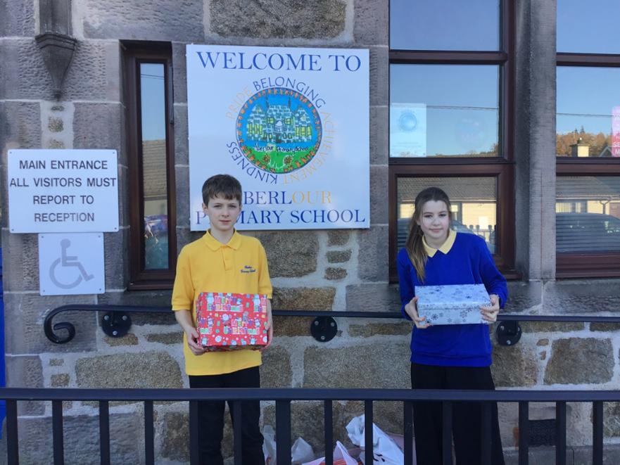 2 senior pupils with school donations for the Ukraine Appeal
