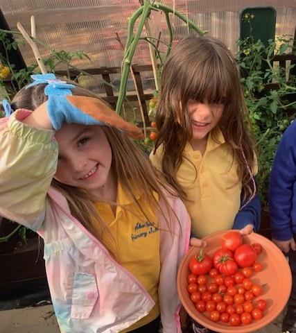 Two children with the tomato harvest from our Aberlour Garden